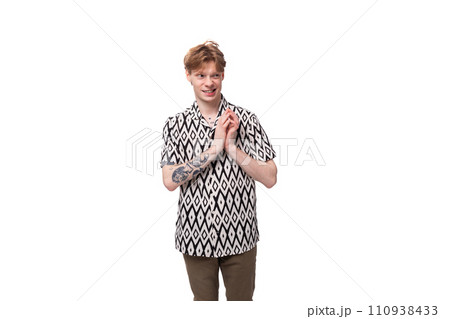 young indignant european man with golden hair is dressed in a stylish black and white shirt on a 110938433