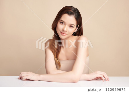 Beautiful young asian woman with clean fresh skin on beige background, Face care, Facial treatment, Cosmetology, beauty and spa, Asian women portrait. Beautiful young asian woman with clean fresh skin on beige background, Face care, Facial treatment, Cosmetology, beauty and spa, Asian women portrait. 110939675