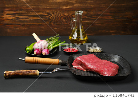 Raw top round beef steak on grill pan 110941743