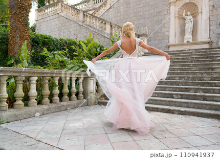 bride in a dress is spinning in a dance 110941937