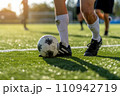 soccer players tackling for the ball 110942719