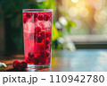 glass of cold red cocktail with ice 110942780