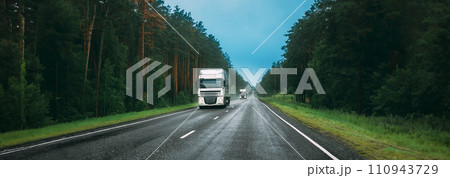 Truck Tractor Unit, Prime Mover, Traction Unit In Motion On Road, Freeway. Asphalt Motorway Highway Against Background Of Forest Landscape. Business Transportation And Trucking Industry 110943729