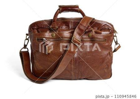 Brown leather briefcase with handles and strap. Vegetable tunned leather bag isolated on white background 110945846