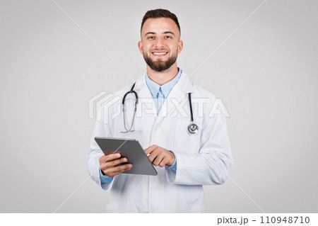 Male doctor holding tablet, friendly and professional Male doctor holding tablet, friendly and professional 110948710