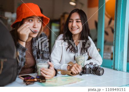 two Asian girls drinking es dawet called traditional Indonesian drink two Asian girls drinking es dawet called traditional Indonesian drink 110949151