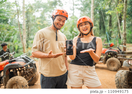 asian couple showing the blank phone to the camera asian couple showing the blank phone to the camera 110949175