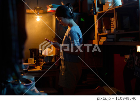 Girl with smartphone cooking food Girl with smartphone cooking food 110949340