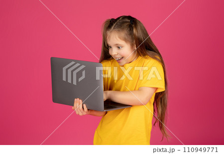 Excited Little Girl Playing Online Games On Laptop Excited Little Girl Playing Online Games On Laptop 110949771
