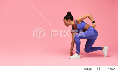 Motivated Black Lady Runner Doing Crouch Start On Pink Background 110949962