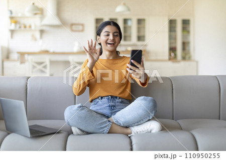 Video Call. Happy Indian Woman Teleconferencing Via Smartphone At Home Video Call. Happy Indian Woman Teleconferencing Via Smartphone At Home 110950255
