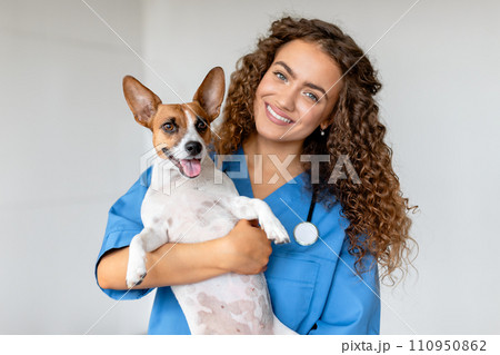 Happy vet holding terrier in clinic Happy vet holding terrier in clinic 110950862