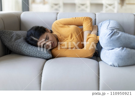 Stomach Ache. Sick Young Indian Female Suffering From Abdominal Pain At Home Stomach Ache. Sick Young Indian Female Suffering From Abdominal Pain At Home 110950921