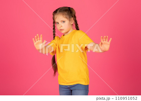 Scared Little Girl Showing Stop Gesture With Hands And Looking At Camera Scared Little Girl Showing Stop Gesture With Hands And Looking At Camera 110951052