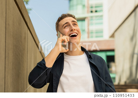 Portrait positive handsome young caucasian man enjoy lifestyle, calling by mobile phone 110951433