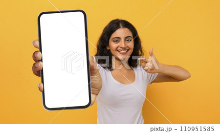 Excited Lady Pointing Finger At Smartphone In Her Hand Excited Lady Pointing Finger At Smartphone In Her Hand 110951585