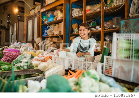 happy greengrocery seller working in farmer market 110951867