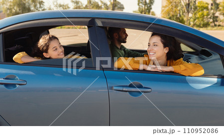 Joyful family in car, mother and daughter looking out 110952086