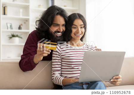 Happy young indian family shopping or banking online from home 110952678