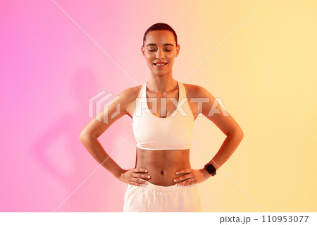 Cheerful slim young latina lady athlete in sportswear with close eyes Cheerful slim young latina lady athlete in sportswear with close eyes 110953077