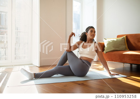 fitness woman practicing yoga doing seated spinal twists indoor 110953258