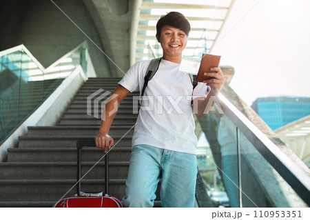Happy young asian man going vacation, showing passport Happy young asian man going vacation, showing passport 110953351