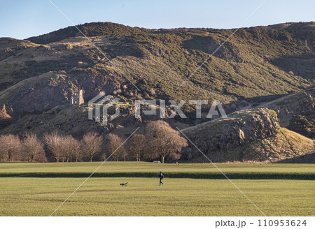 The breathtaking scenic landscape of Holyrood park with Salisbury Crags rugged hills and sky background. 110953624