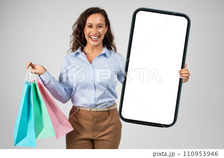 Happy young caucasian lady in formal wear, many purchases bags, enjoy shopping 110953946