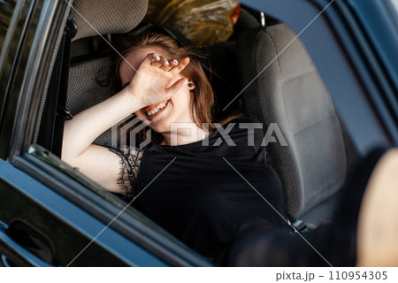 sexy girl driving a car. the girl pulled her legs out of the car window.girl laughs and flirts. sexy legs in pantyhose sexy girl driving a car. the girl pulled her legs out of the car window.girl laughs and flirts. sexy legs in pantyhose 110954305