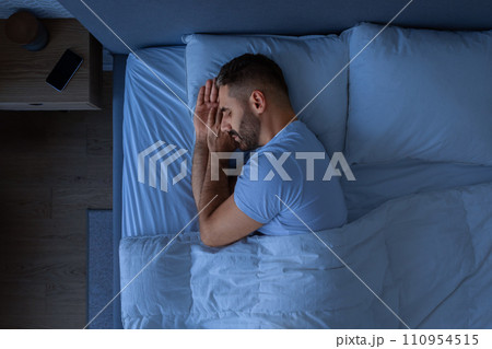 Guy Sleeping Holding Hands Near Face Enjoying Rest In Bedroom Guy Sleeping Holding Hands Near Face Enjoying Rest In Bedroom 110954515