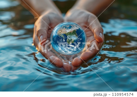 An evocative and symbolic World Water Day, featuring hands cupping clear, clean water with a reflection of the Earth, emphasizing the global significance of water conservation and sustainability 110954574