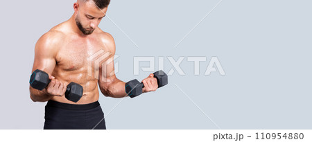 Calm sweat strong muscular young caucasian man with beard, naked torso make exercises with dumbbell Calm sweat strong muscular young caucasian man with beard, naked torso make exercises with dumbbell 110954880
