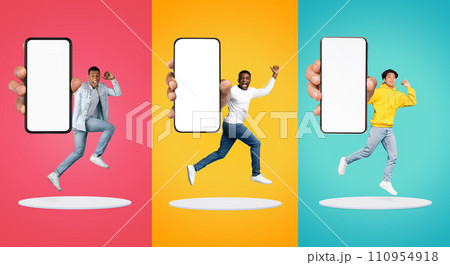 Cheerful excited young black and asian people show big smartphone with empty screen 110954918