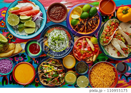 A colorful and appetizing top view of Mexican festive food for Independence Day, featuring chili, cilantro, tacos, burritos, chalupas, pozole, tamales, and chicken with mole poblano sauce. A colorful and appetizing top view of Mexican festive food for Independence Day, featuring chili, cilantro, tacos, burritos, chalupas, pozole, tamales, and chicken with mole poblano sauce. 110955175