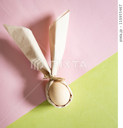 egg wrapped in easter bunny shaped napkin egg wrapped in easter bunny shaped napkin 110955467