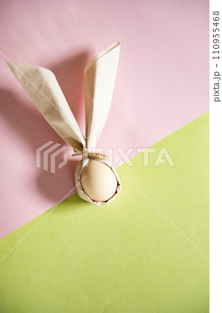 egg wrapped in easter bunny shaped napkin 110955468