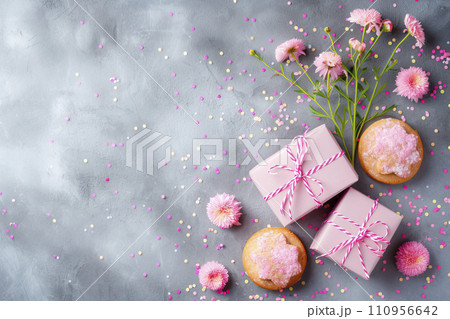 Biscuit dessert flowers and pink gift boxes with confetti on grey background, top view, copy space, mothers day and easter concept Biscuit dessert flowers and pink gift boxes with confetti on grey background, top view, copy space, mothers day and easter concept 110956642