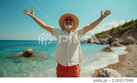 A joyful man in a wicker hat and red shorts stands with his hands up on the beach A joyful man in a wicker hat and red shorts stands with his hands up on the beach 110957066