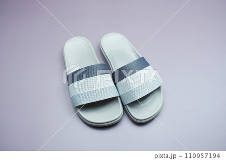 Gray slide sandal summer slippers on purple background Gray slide sandal summer slippers on purple background 110957194