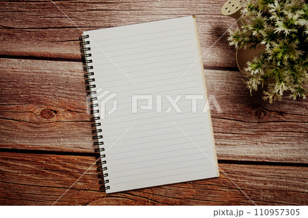 Empty Notebook open on wooden background 110957305