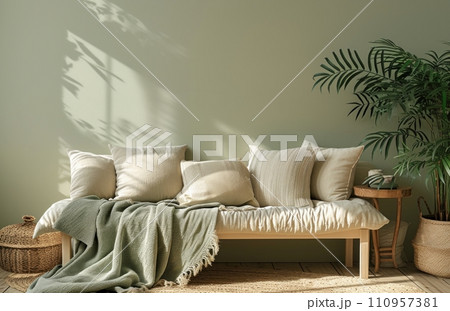 a sofa with blankets, a plant and a table a sofa with blankets, a plant and a table 110957381