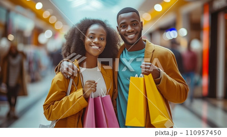 A woman and her boyfriend are all smiles as they enjoy a day of shopping together at the mall A woman and her boyfriend are all smiles as they enjoy a day of shopping together at the mall 110957450