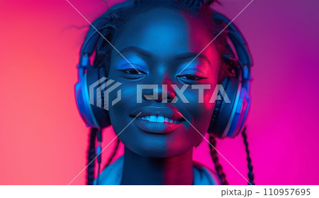 a young woman with headphones and headphones on is smiling a young woman with headphones and headphones on is smiling 110957695