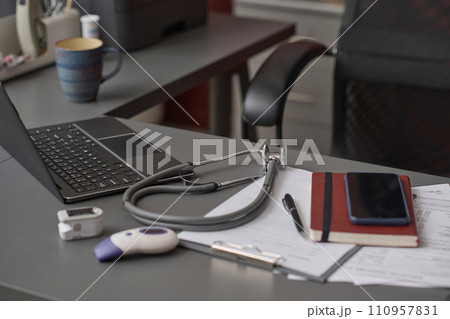 Empty workplace at hospital office with documents and equipment of physician displayed on table 110957831