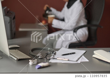 Selective focus of medical equipment placed on office table, doctor having lunch break on background 110957835