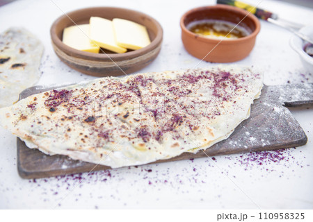 Front view of stylish. wooden board with flour and pita, shawurma lying on white table outdoor. Concept of fast food. Front view of stylish. wooden board with flour and pita, shawurma lying on white table outdoor. Concept of fast food. 110958325