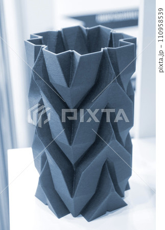 Art object vase printed on a 3D printer. Models created by a 3D printer from blue molten plastic. Concept 3d printing. Additive progressive technologies. New modern technology for creating objects 110958539
