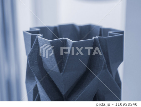 Art object vase printed on a 3D printer. Models created by a 3D printer from blue molten plastic. Concept 3d printing. Additive progressive technologies. New modern technology for creating objects 110958540