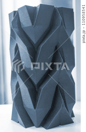 Art object vase printed on a 3D printer. Models created by a 3D printer from blue molten plastic. Concept 3d printing. Additive progressive technologies. New modern technology for creating objects 110958541