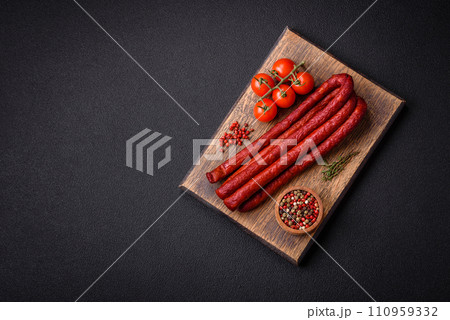 Delicious thin smoked hunting sausages with salt, spices and herbs Delicious thin smoked hunting sausages with salt, spices and herbs 110959332